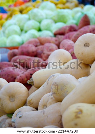 Fresh colorful produce in a Tel Aviv fruit and vegetable market: squash, yams, cabbage, and more
