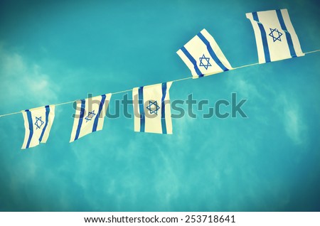 Israel flags in a chain in white and blue showing the Star of David hanging proudly for Israel\'s Independence Day (Yom Haatzmaut) - vintage retro effect