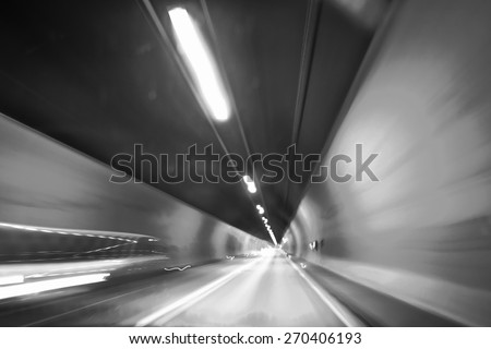 Cars in a tunnel - Snow shutter speed abstract car tunnel effect showing motion and speed - black and white