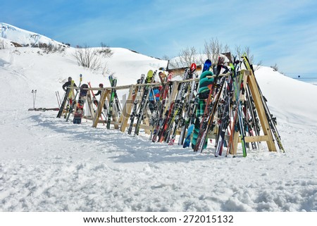 LECH, AUSTRIA - APRIL 10, 2015: A rack packed with skis and poles after a day of skiing at the Lech - Zurs ski resort in Arlberg, Tyrol, Austria