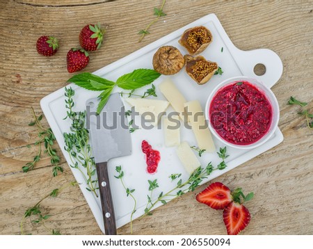 Cheese and fruit set on a wooden surface