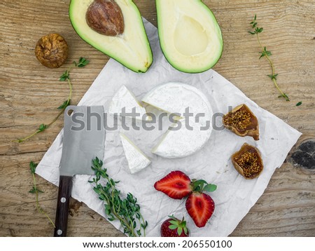 Cheese and fruit set on a wooden surface