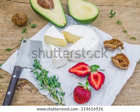 Cheese and fruit set on a rough wooden desk