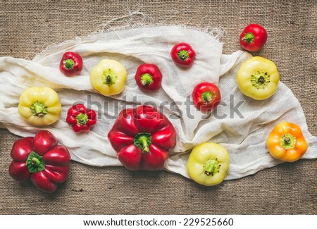Sweet paprika set on a piece of white linen fabric over a sackcloth background