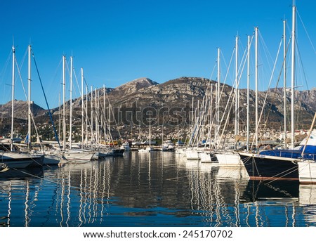 Ships in the yacht marine of Bar, Montenegro, Balkan peninsula. 13.01.2015: the view of yachts in the marina of Bar with mountains at the backdrop on a clear sunny winter day