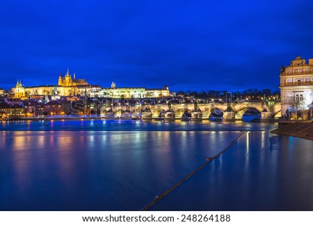 Evening view of the Prague castle, Charles bridge and the Vltava river in the evening lights from Smetana embankment. Prague, Czech Republic, end of December, blue hour.