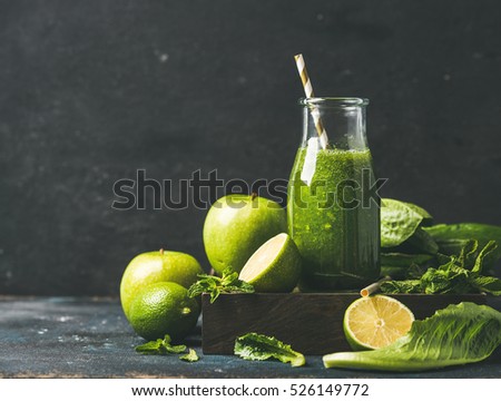 Green smoothie with apple, romaine lettuce, lime and mint, dark blue background, selective focus, copy space. Detox, dieting, clean eating, vegetarian, vegan, fitness diet or healthy lifestyle concept