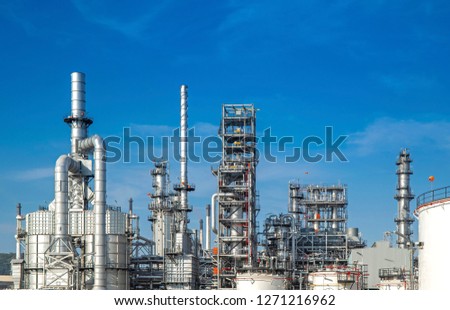 Oil and gas industrial,Oil refinery plant form industry,Refinery factory oil storage tank and pipeline steel with sunset and cloudy sky background,Thailand