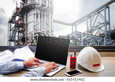 Engineering Industry concept in office with Oil and gas Industry,Refinery at sunset ,Pipelines and petrochemical plant background