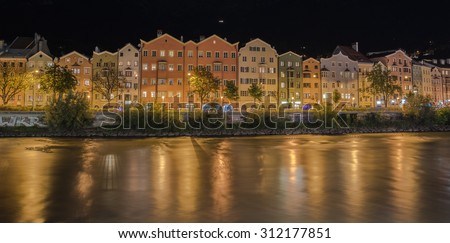 MARIA HILFER-ST. NICOLAS District, INNSBRUCK, AUSTRIA-August 22, 2015: A row of houses, apartments, offices, hotels, restaurants, along the left bank of river Inn at night