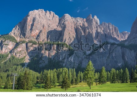 At the foot of northern cliffs of Sella mountain group, as taken from the route to Pisciadu waterfall, near by the road to Gardena pass from Colfosco village, Val Badia, Dolomites, South Tyrol, Italy