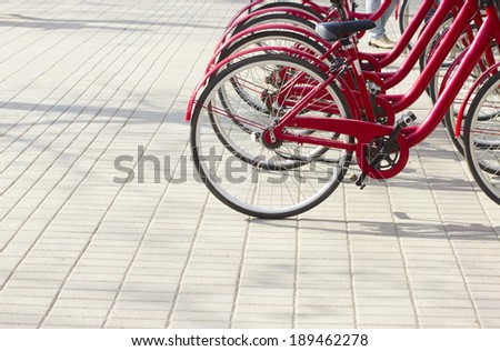 raw of red bicycles for rent, eco city background