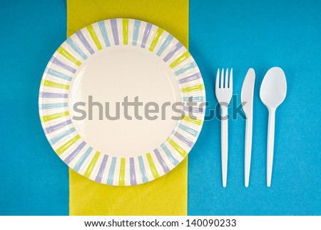 Picnic disposable dishware setting on paper tablecloth
