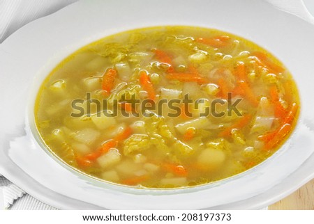Savoy cabbage soup served in a white plate