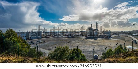 Panoramic view to the oil-processing plant in Øygarden region in Norway near Bergen, with cumulus clouds in the sky