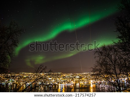 Northern lights in the sky above Tromso city in northern Norway