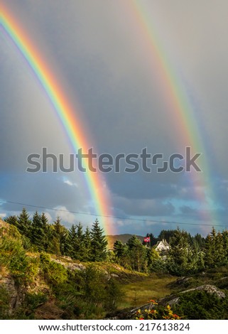 Double rainbow in sky over the forest in Oygarden islands in Horoland, Norway