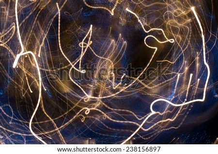 Flight trough the universe - abstract background with light trails from rotating city neon lights