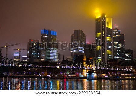 FRANKFURT, GERMANY - CIRCA DECEMBER 2014: Evening panorama of Frankfurt Skyline (skyscrapers in downtown) in cloudy weather at night, view from Main river - architecture background