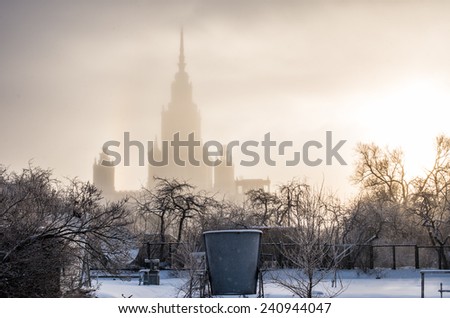 Silhouette of main building of Lomonosov Moscow State University in winter frosty fog at sunset. Sparrow Hills, Moscow, Russia. The highest among seven Stalin\'s soviet skyscrapers built in mid-20th.