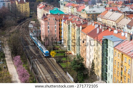 Urban train going along bright colored vintage residential buildings in Vysehrad district in Prague, Czech republic - urban background