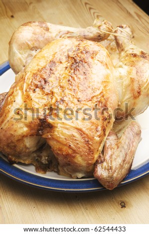 Traditional Sunday dinner. Delicious Roasted Chicken ready to serve at the kitchen table