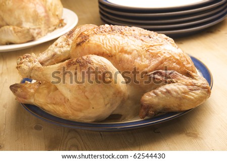 Traditional Sunday dinner. Delicious Roasted Chicken ready to serve at the kitchen table