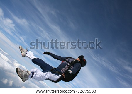 Skydiver falls through the air on his back