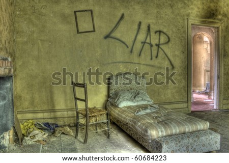 HDR photo of bed in derelict house. Graffiti against wall