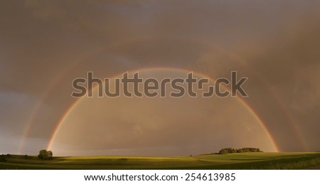 Full rainbow at cloudy weather