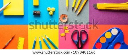 Set of school and preschool childrens accessories for learning letter drawing education on background of multi colored paper Concept Back to school copy space close-up top view.
