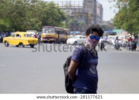 Local people cover face with hanky and sunglass to be safe from extreme heat wave on May 23, 2015 in Calcutta, India.