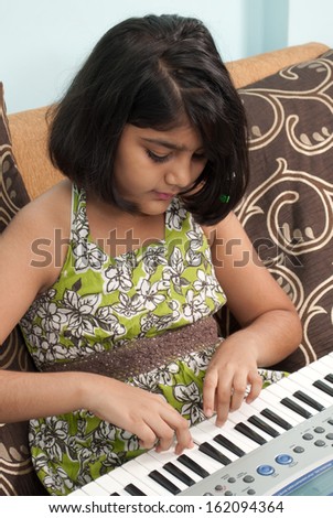 Indian little girl play music