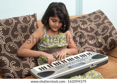 Indian little girl play music
