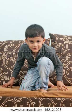Indian little boy get set ready play on bed
