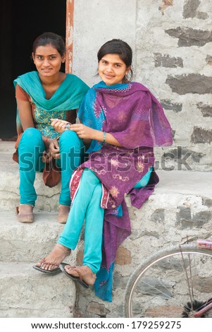 MAHARASHTRA, INDIA - May 12, 2013: two girls in front of their house  in a rural village at Salunkwadi, Beed in Maharashtra, India.