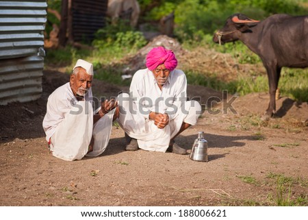 Two old farmers having sunlight in the morning, rural village Salunkwadi, Beed, Maharashtra, India