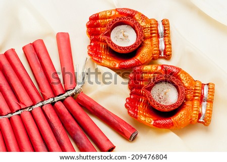 Firecrackers and Diwali lamp on silk background, Diwali festival India Asia South East Asia