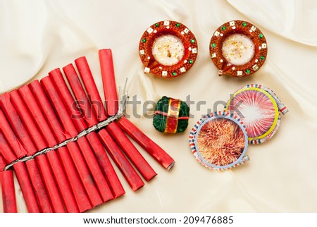 Firecrackers and Diwali lamp on silk background, Diwali festival India Asia South East Asia