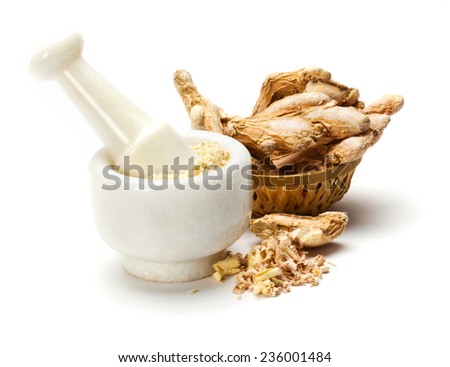 Dry ginger root grated in pestle and mortar isolated on white background