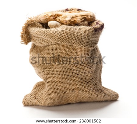 Dry ginger root in jute bag isolated on white background