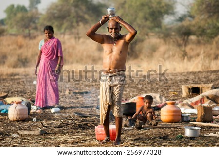 BEED, MAHARASHTRA, INDIA - March 25, 2012: old Shepherd man bathing rural village Salunkwadi