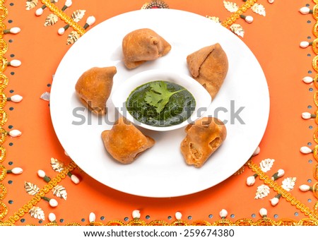 Samosa Indian traditional fast food snack dish isolated on decorative background in festival time