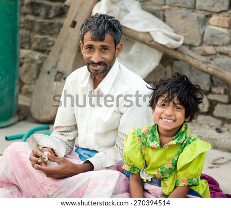 MAHARASHTRA, INDIA - April 23, 2011: Father and daughter in the bed in rural village Salunkwadi Ambajogai Beed Maharashtra India asia
