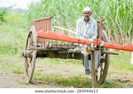 Farmer in empty bull cart, rural village, Salunkwadi, Ambajogai, Beed, Maharashtra, India.