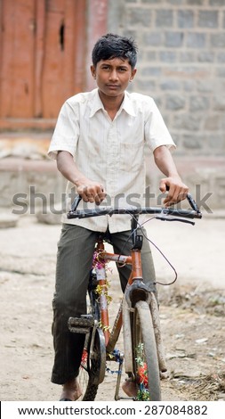 MAHARASHTRA, INDIA SEPTEMBER 22, 2011: Indian rural boy playing bicycle, SEPTEMBER 22, 2011, rural village, Salunkwadi, Ambajogai, Beed, Maharashtra, India