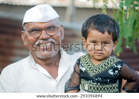Indian rural baby girl with grand father closeup Salunkwadi, Ambajaogai, Beed, Maharashtra, India, South East Asia