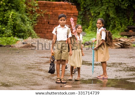 MAHARASHTRA, INDIA July 9, 2011: Fisherman children going to school in rainy days, July 9, 2011, Portuguese port Vasai, Mumbai, Maharashtra; India, Southeast, Asia.
