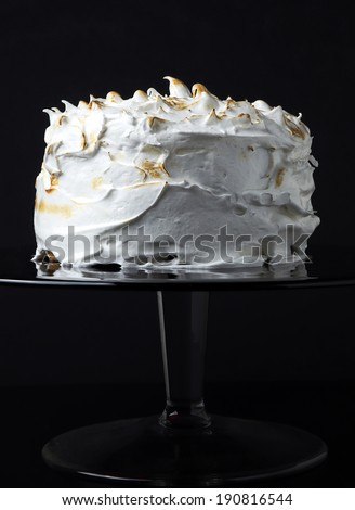 White sponge cake with icing on black