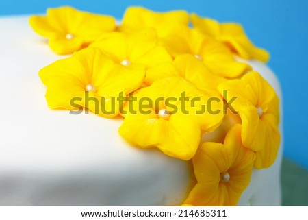 Birthday cake with yellow flowers closeup